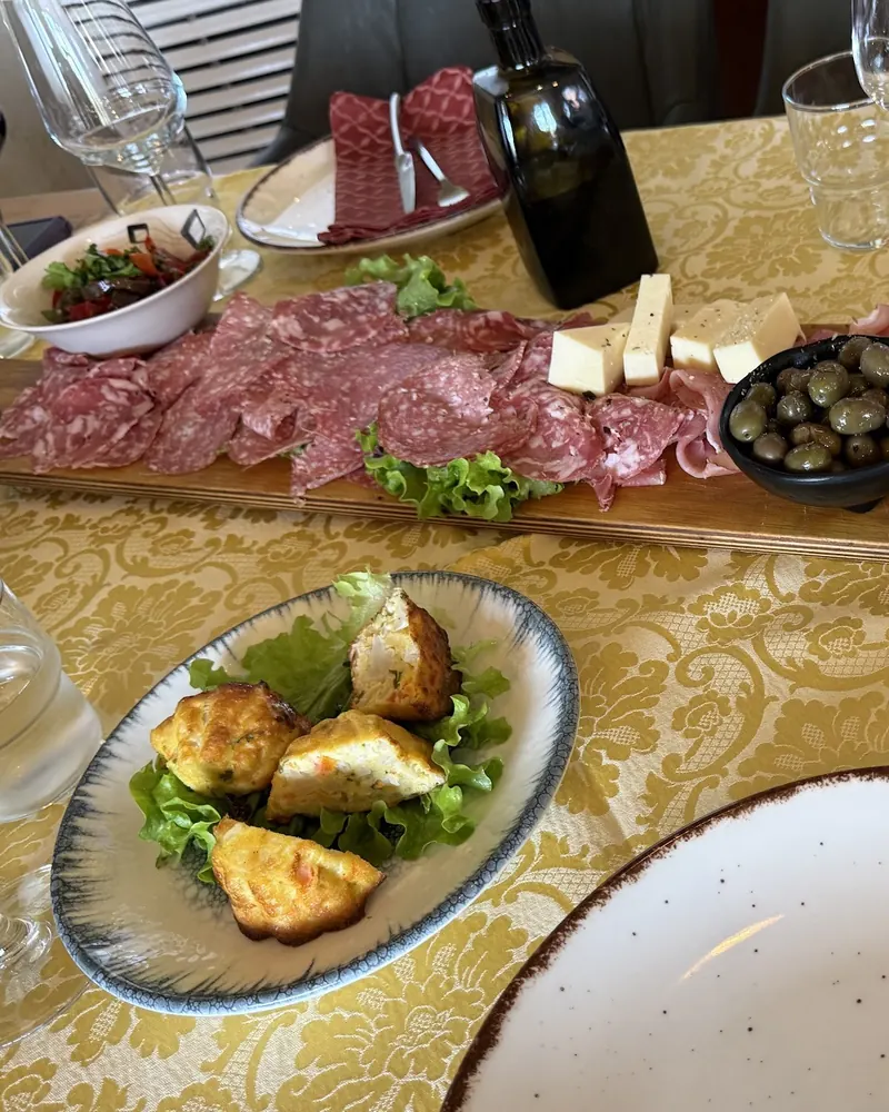 Cured meats, cheese, olives and fried bites on the table