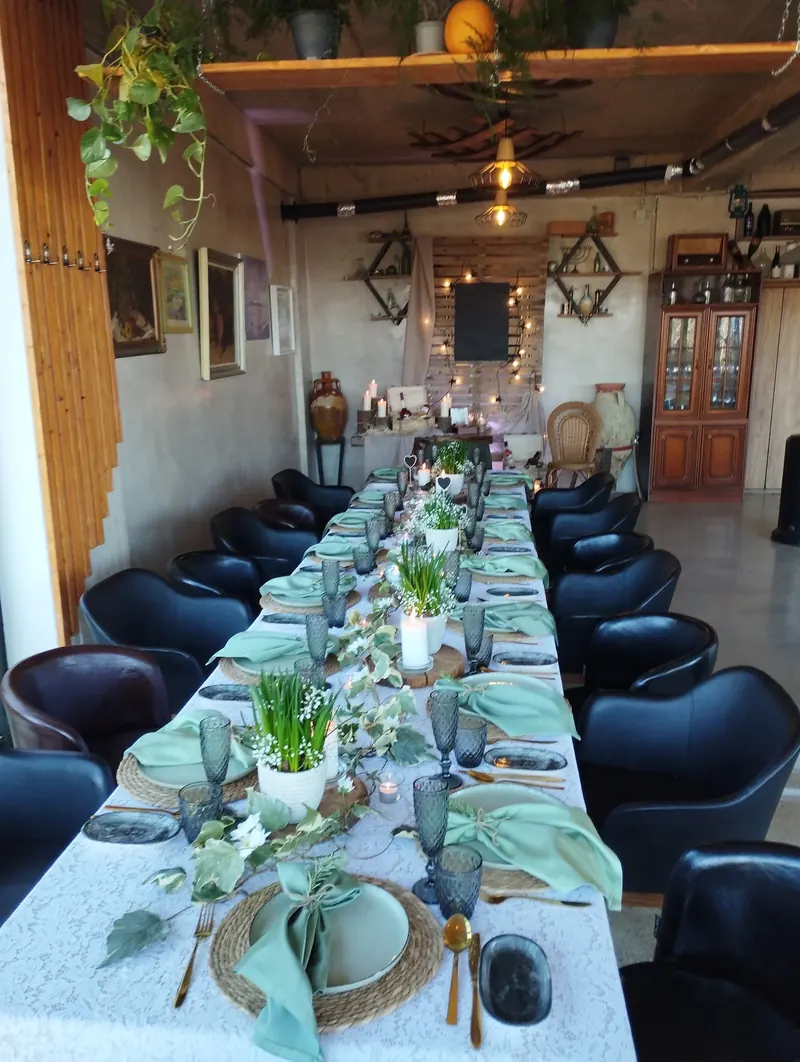 A long table set with flowers and green napkins